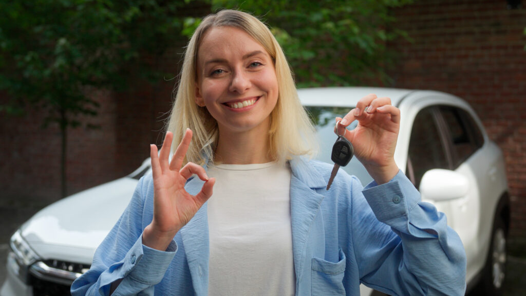 Smiling driver holding car keys after auto electrical service by QG Auto Electrical in Stafford, Brisbane.